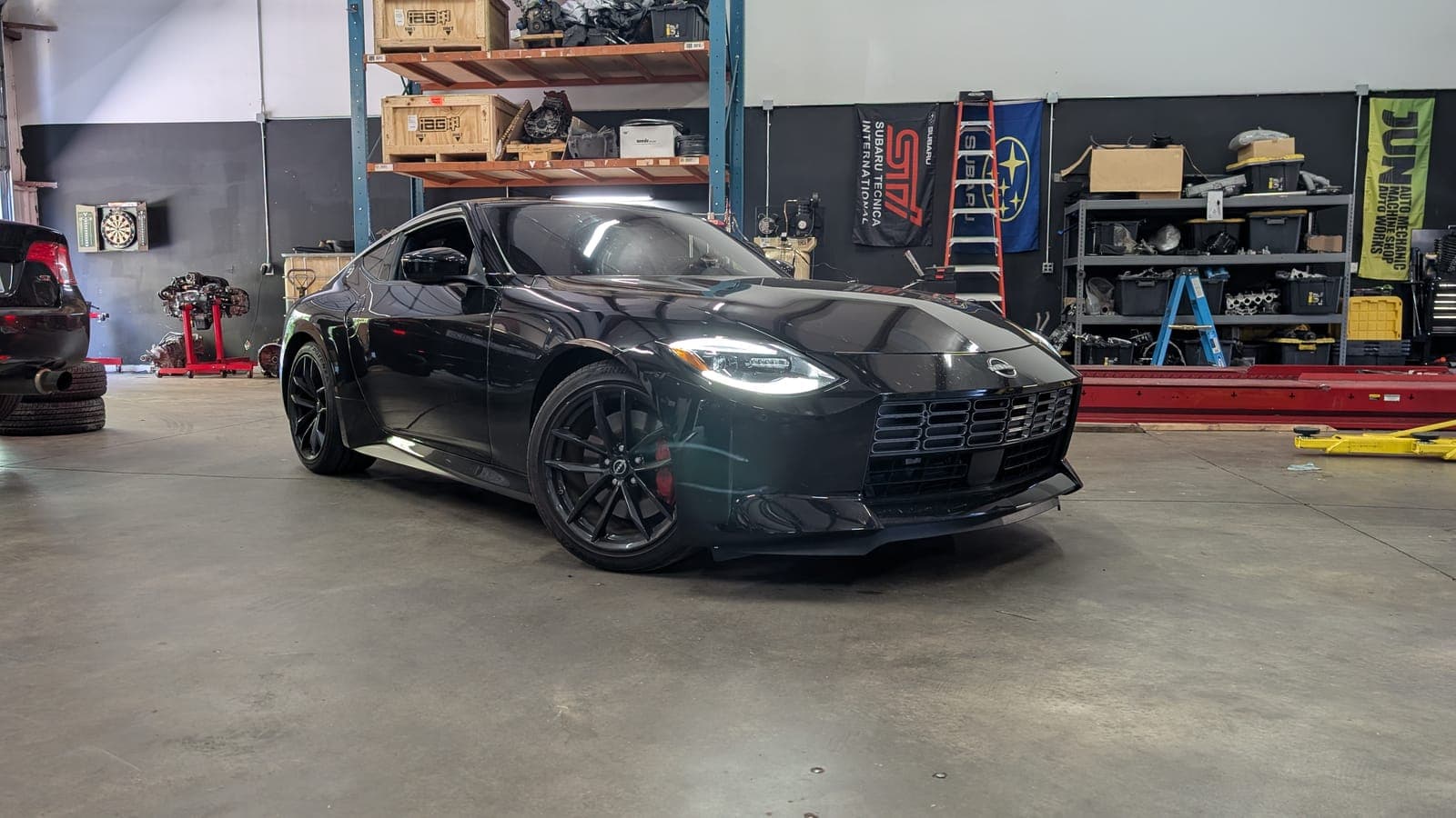 Black Nissan Z, RZ34, on black wheels on the shop floor at Streamline Performance Garage in Concord, NC